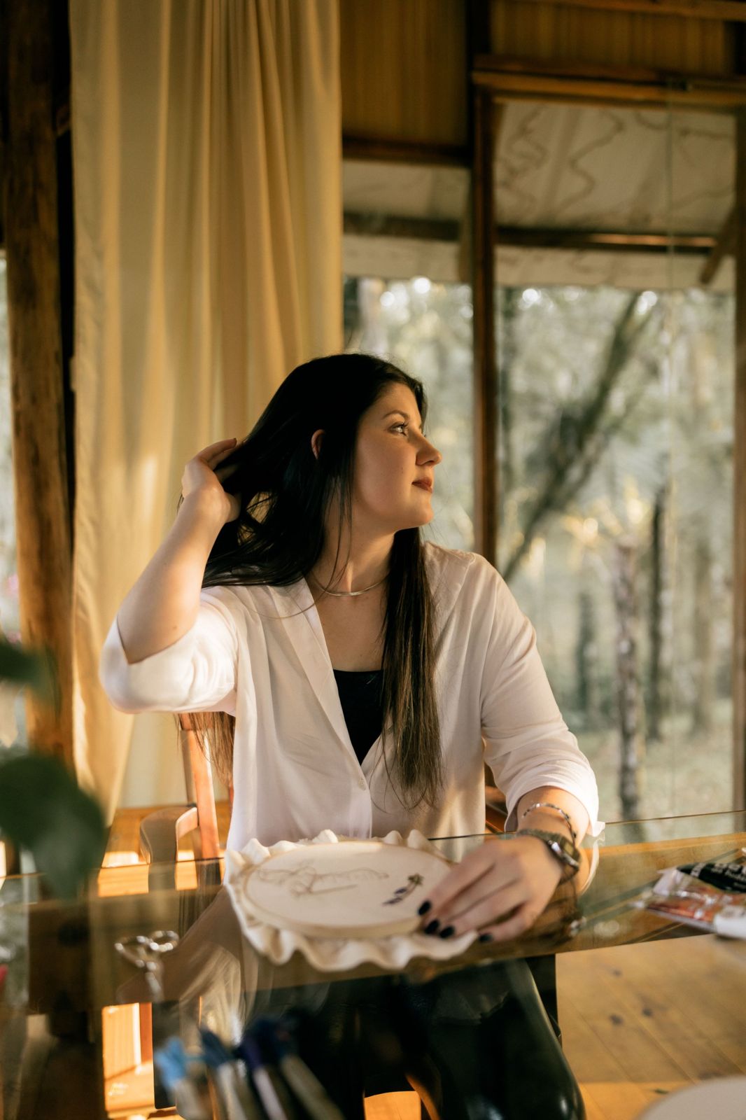 A woman at a table by a window